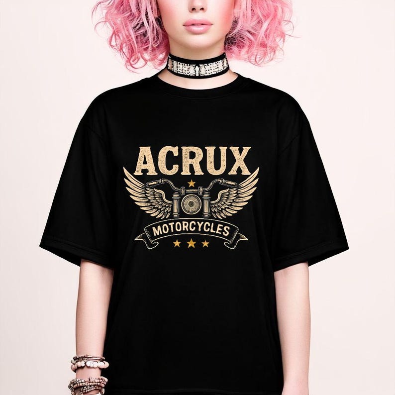 May include: A black short-sleeve t-shirt featuring a gold graphic print on the chest. The design displays the text ACRUX above a stylized motorcycle handlebar with wings, the word MOTORCYCLES on a banner, and three small stars below the banner.