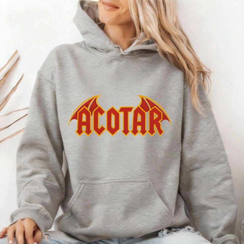 Light gray hoodie with bold red and yellow 'ACOTAR' lettering and bat-wing graphics, styled as fan merch for lovers of 'A Court of Thorns and Roses' — cozy apparel for fantasy readers and bookish introverts drawn to gothic motifs and high-fae lore.