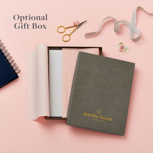 An image of an optional gift box. The gift box is dark grey and features the martha brook logo on the bottom centre of the lid.