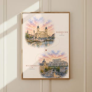 Op de afbeelding: Een ingelijste kunstdruk met twee cirkelvormige aquarelillustraties van stadsgezichten. De bovenste afbeelding toont Debrecen, Hongarije, en de onderste Boekarest, Roemenië. Een dunne stippellijn met een klein hartje verbindt beide locaties.