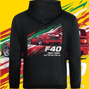 May include: Black hooded sweatshirt featuring a red sports car graphic with Italian flag colors. The design includes the text "F40 1987-1992 Fatto in Italia". The car is a classic model.