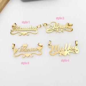 May include: Four gold-colored nameplate pendants with different styles. The names "Claudia", "Aleshia", "Marian", and "Malky" are displayed on the pendants. Each pendant features a heart design and a different style of font.