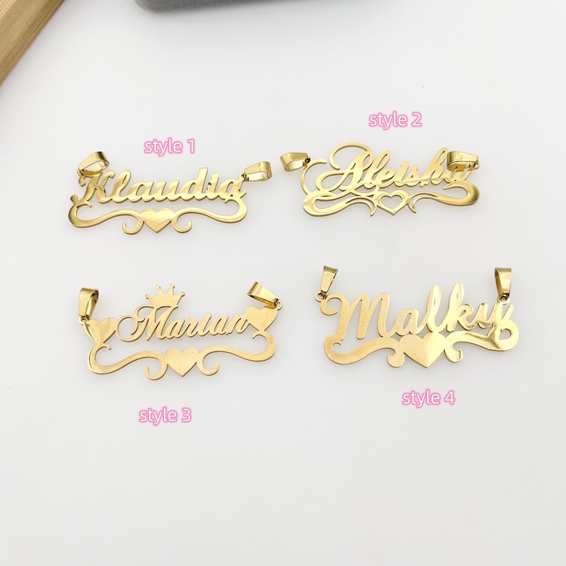 May include: Four gold-colored nameplate pendants with different styles. The names "Claudia", "Aleshia", "Marian", and "Malky" are displayed on the pendants. Each pendant features a heart design and a different style of font.