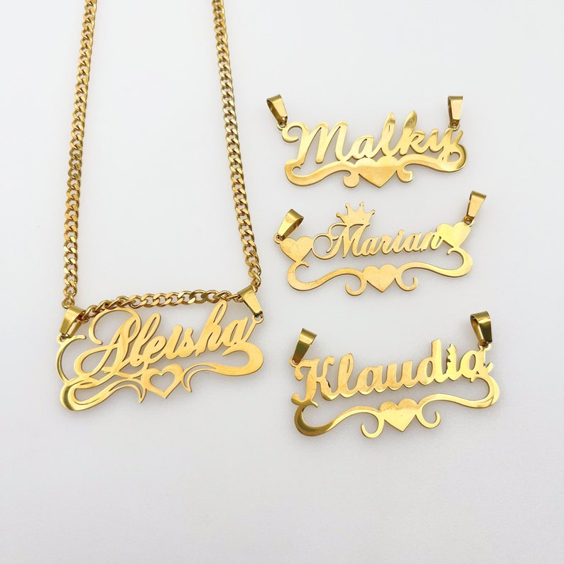 May include: Four gold-tone nameplate necklaces with heart accents. The names on the necklaces are "Alesha", "Malky", "Marian", and "Klaudia".