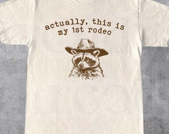 Actually, This Is My First Rodeo T-Shirt | Funny Western Graphic Tee | Raccoon Quote | Retro Shirt Unique Gift Idea | Unisex Shirt