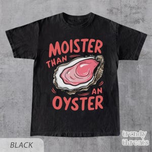 May include: Black t-shirt with a graphic of an oyster and the text "Moister than an oyster".