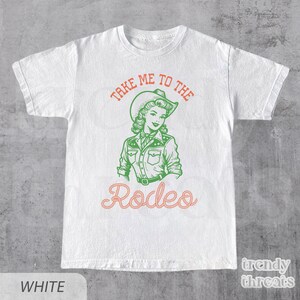 White Shirt With The quote: Take Me To The Rodeo