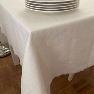Handmade tablecloth made of washed linen with fringes in cream