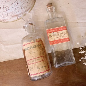 Transparent glass bottles with vintage label - military and perfume -