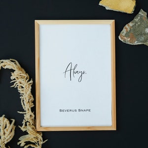 May include: A framed print with the words "Always" and "Severus Snape" in black text on a white background. The frame is made of light wood and is sitting on a black surface.