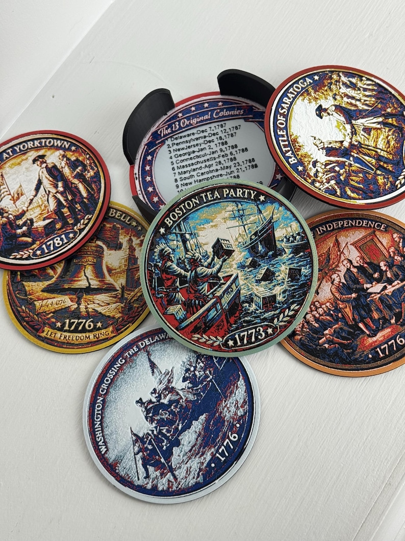 May include: A collection of round coasters featuring historical American Revolution scenes and text. The coasters depict events like the Boston Tea Party, the Battle of Saratoga, and the signing of the Declaration of Independence. Each coaster has a different illustration and the year 1776 or 1773.