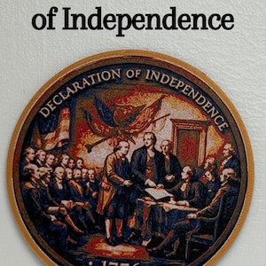 May include: A round, wooden coaster featuring a detailed depiction of the signing of the Declaration of Independence. The text "Signing Declaration of Independence" is at the top, with "Declaration of Independence" around the image. The year "1776" is at the bottom.