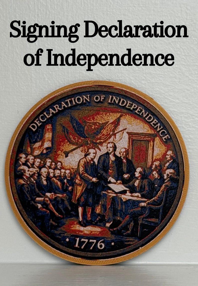 May include: A round, wooden coaster featuring a detailed depiction of the signing of the Declaration of Independence. The text "Signing Declaration of Independence" is at the top, with "Declaration of Independence" around the image. The year "1776" is at the bottom.