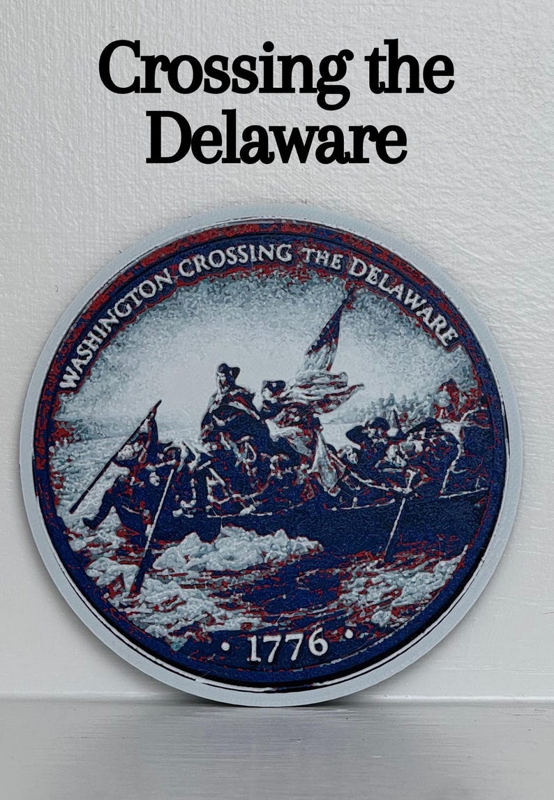 May include: A round, blue, red, and white graphic depicting the historical event, "Crossing the Delaware." The image features a boat with soldiers and the text "Washington Crossing the Delaware" and "1776."
