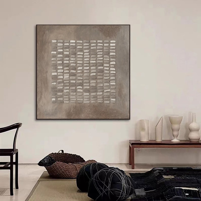 May include: A square abstract painting with a grid pattern of white and gray rectangles on a brown background.