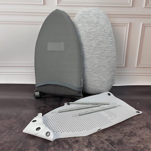 May include: A set of ironing accessories including a gray and a light gray ironing board cover, a white ironing board pad with a grid pattern, and four silver metal rods.