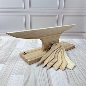 Peut inclure: Une planche à découper en bois avec un support en forme d'enclume en bois et un ensemble de six outils en bois. La planche est gravée du texte "Handmade Craft".