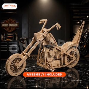 May include: A wooden motorcycle model with intricate details, featuring a light brown color. The model has a classic chopper design, with visible engine components and spoke wheels. The text "ASSEMBLY INCLUDED" is displayed on an orange banner.