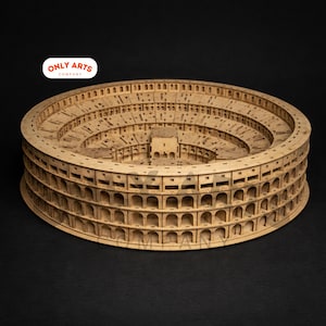 May include: A detailed wooden model of the Colosseum, featuring multiple levels of arches and seating. The model is made of light brown wood and is a replica of the historic Roman amphitheater. The Only Arts Company logo is visible.