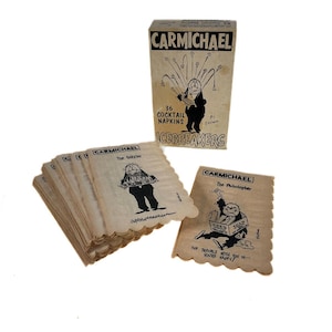 May include: A vintage set of Carmichael Icebreakers cocktail napkins. The box features a cartoon image and the text "36 Cocktail Napkins." Individual napkins show cartoon figures with text. The napkins have a scalloped edge.