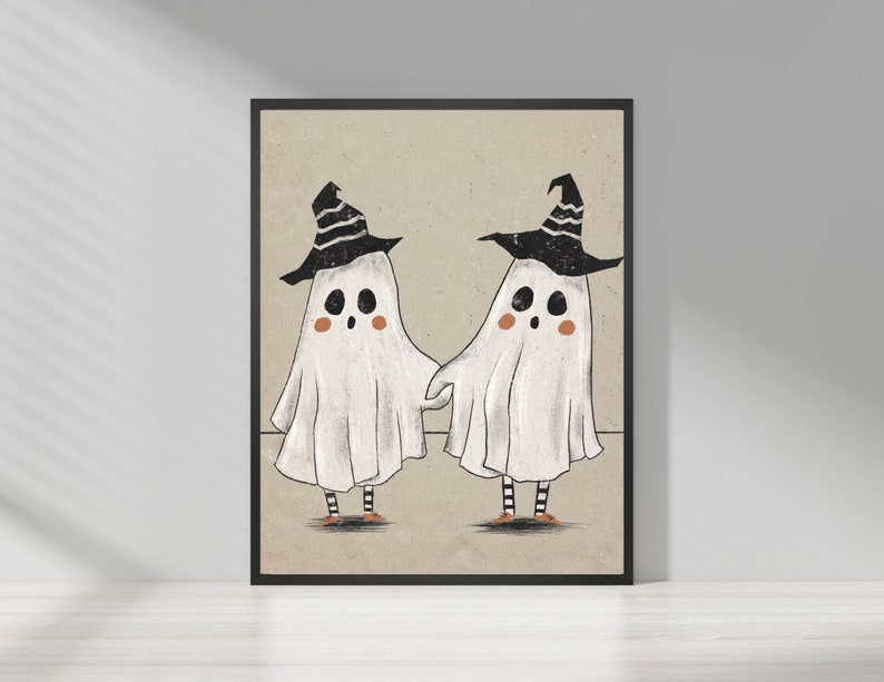 May include: Two white ghosts wearing black witch hats with orange shoes. The ghosts are holding hands and smiling.