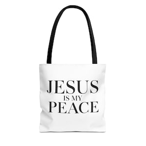 Peut inclure: Un sac fourre-tout blanc avec le texte noir JESUS IS MY PEACE écrit dans une police serif grasse. Le sac est doté de deux anses noires fixées sur le dessus, offrant un design simple et fonctionnel pour transporter divers objets personnels.