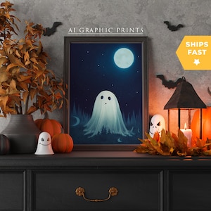 May include: A framed print of a ghost in a forest at night with a full moon and stars. The print is on a black dresser with a pumpkin, a ghost figurine, and a lantern with a candle.