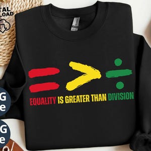 May include: Black sweatshirt with a graphic design of an equals sign, a greater than sign, and a division sign. The signs are coloured red, yellow, and green. The text "Equality is greater than division" is printed below the graphic.