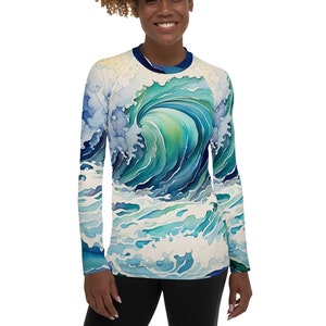 May include: A long-sleeved shirt with a blue and green watercolor wave design. The wave is depicted in a Japanese style, with a white background.