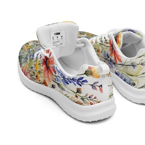 Women's Watercolor Wildflowers Sneakers : Athleisure Casual Shoes, Lightweight, Lace-up, Floral, Flowers. Vibrant watercolor wildflowers in shades of orange, blue, yellow, and pink, with green leaves and foliage, against a crisp white background. Bright white inner and outer soles, trim and shoelaces. The upper is a ultralight knit weave. These casual shoes are perfect for travel, shopping, running errands or just hanging out. Super lightweight and comfortable.