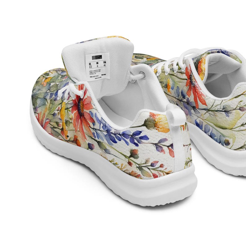 Women's Watercolor Wildflowers Sneakers : Athleisure Casual Shoes, Lightweight, Lace-up, Floral, Flowers. Vibrant watercolor wildflowers in shades of orange, blue, yellow, and pink, with green leaves and foliage, against a crisp white background. Bright white inner and outer soles, trim and shoelaces. The upper is a ultralight knit weave. These casual shoes are perfect for travel, shopping, running errands or just hanging out. Super lightweight and comfortable.