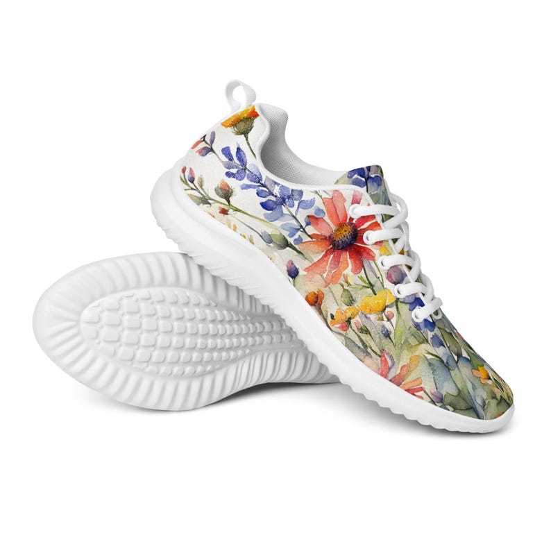 Women's Watercolor Wildflowers Sneakers : Athleisure Casual Shoes, Lightweight, Lace-up, Floral, Flowers. Vibrant watercolor wildflowers in shades of orange, blue, yellow, and pink, with green leaves and foliage, against a crisp white background. Bright white inner and outer soles, trim and shoelaces. The upper is a ultralight knit weave. These casual shoes are perfect for travel, shopping, running errands or just hanging out. Super lightweight and comfortable.