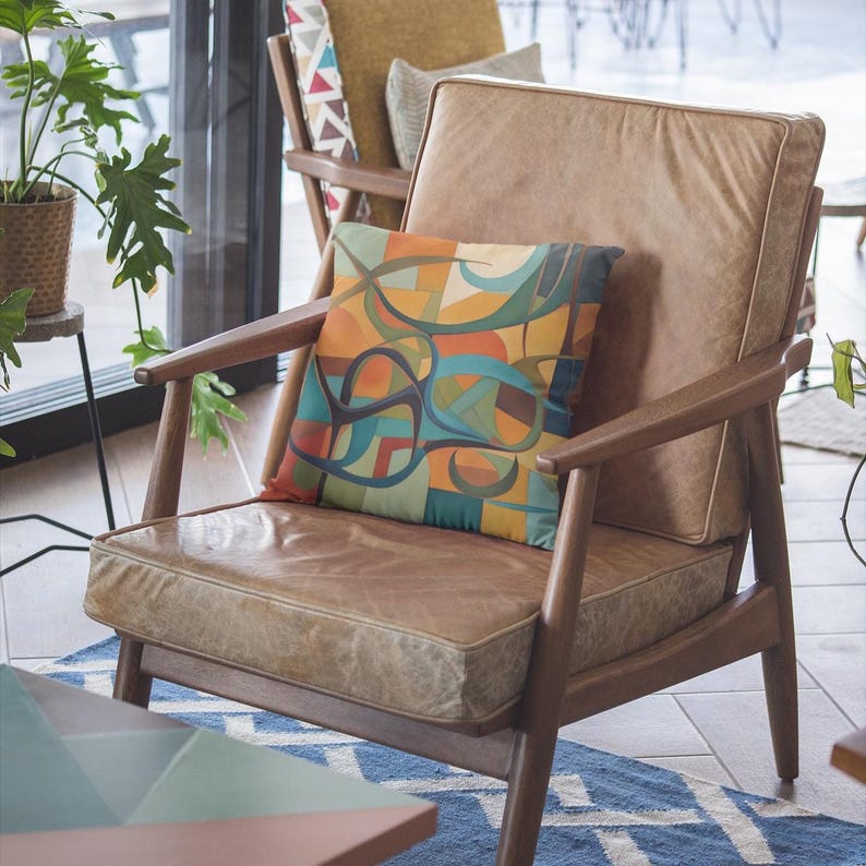 Original abstract art painting in mid century modern tones of olives, rusts, teals and blue, featuring boomerangs and geometric shapes, vibrantly printed on both sides of this linen textured pillow cover. It has a hidden black zipper for easy removal, cover is preshrunk and machine washable. MCM.
