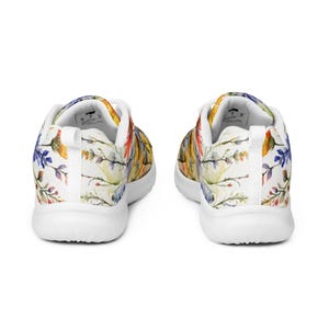 Women's Watercolor Wildflowers Sneakers : Athleisure Casual Shoes, Lightweight, Lace-up, Floral, Flowers. Vibrant watercolor wildflowers in shades of orange, blue, yellow, and pink, with green leaves and foliage, against a crisp white background. Bright white inner and outer soles, trim and shoelaces. The upper is a ultralight knit weave. These casual shoes are perfect for travel, shopping, running errands or just hanging out. Super lightweight and comfortable.
