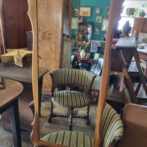 hanging mirror in a wooden frame