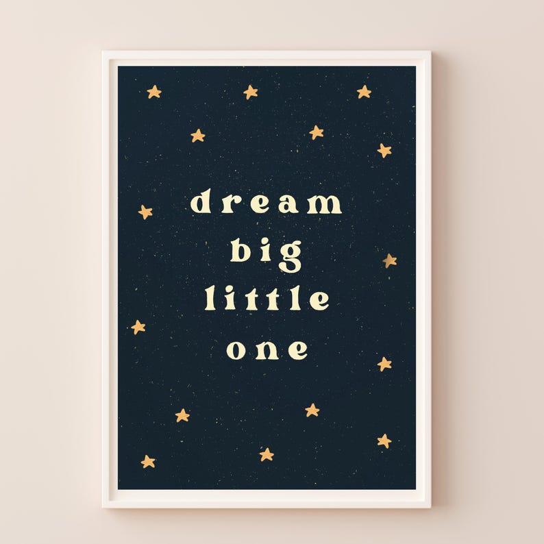 May include: A dark blue printable poster with gold stars and the text "dream big little one" in a light yellow font.