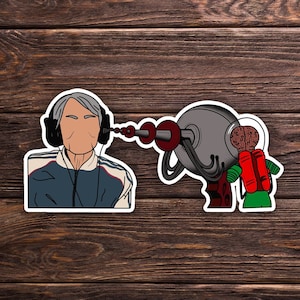 May include: A cartoon illustration of a person wearing headphones and a blue jacket, being targeted by a ray gun held by a cartoon alien with a brain for a head.