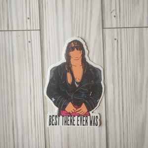 May include: A black and white sticker of a wrestler wearing a black leather jacket and sunglasses. The text "BEST THERE EVER WAS" is below the image.