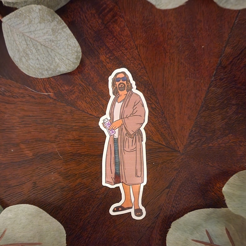 May include: A sticker of a cartoon man wearing a brown robe, sunglasses, and holding a purple bottle. The man is standing on a brown wooden surface.
