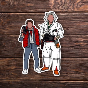 May include: Two cartoon figures, one wearing a red jacket and the other wearing a white lab coat, stand side-by-side. The figure in the red jacket is holding a camera and the figure in the white lab coat is holding a device.