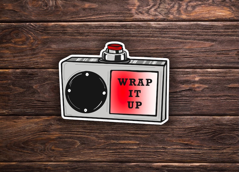 May include: A silver and red cartoon illustration of a device with a button that says "WRAP IT UP". The device has a round speaker and a red button on top.