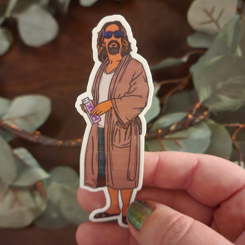 May include: A sticker of a man wearing a brown robe and sunglasses, holding a purple and white bottle with the word "Milk" on it.