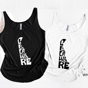 May include: Two tank tops, one black and one white, with the state of Delaware's outline filled with the word "Delaware" in a stacked design. The white tank top has the word "WHITE" printed on the bottom right.