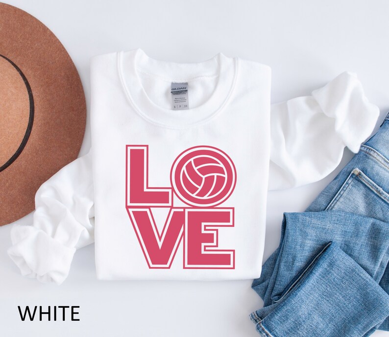 May include: White sweatshirt with the word "LOVE" in red with a volleyball graphic in the "O".
