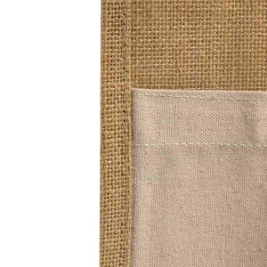 May include: A close-up of a brown burlap fabric with a beige canvas pocket sewn on. The pocket has a stitched seam around the edge.