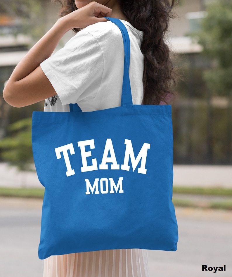 May include: A royal blue tote bag with white text that reads "TEAM MOM".