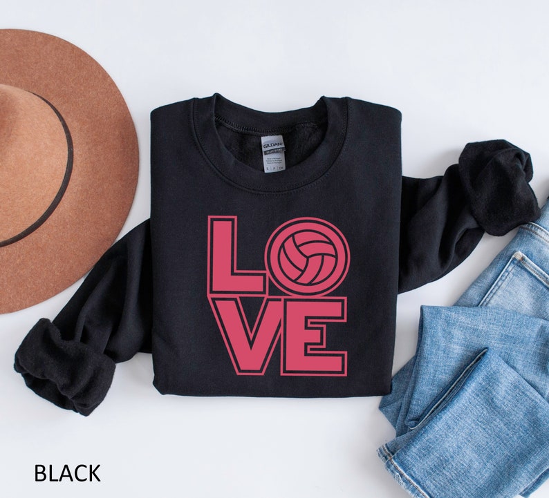 May include: Black sweatshirt with a pink graphic of the word "LOVE" with a volleyball in the "O".
