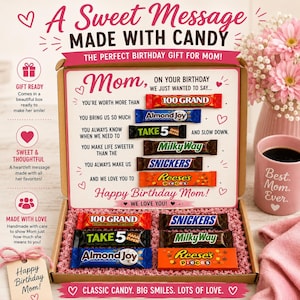 May include: A cardboard gift box containing assorted candy bars including 100 Grand, Almond Joy, Take 5, Milky Way, Snickers, and Reese's Pieces. The box lid features printed text messages for a birthday, decorated with pink hearts and graphics.