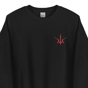 May include: Black sweatshirt with a red stylized arrow design on the front.