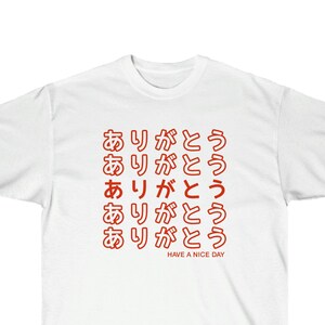 May include: White t-shirt with the Japanese phrase "Arigato" (thank you) repeated multiple times in red. The text "Have a nice day" is printed below the phrase.